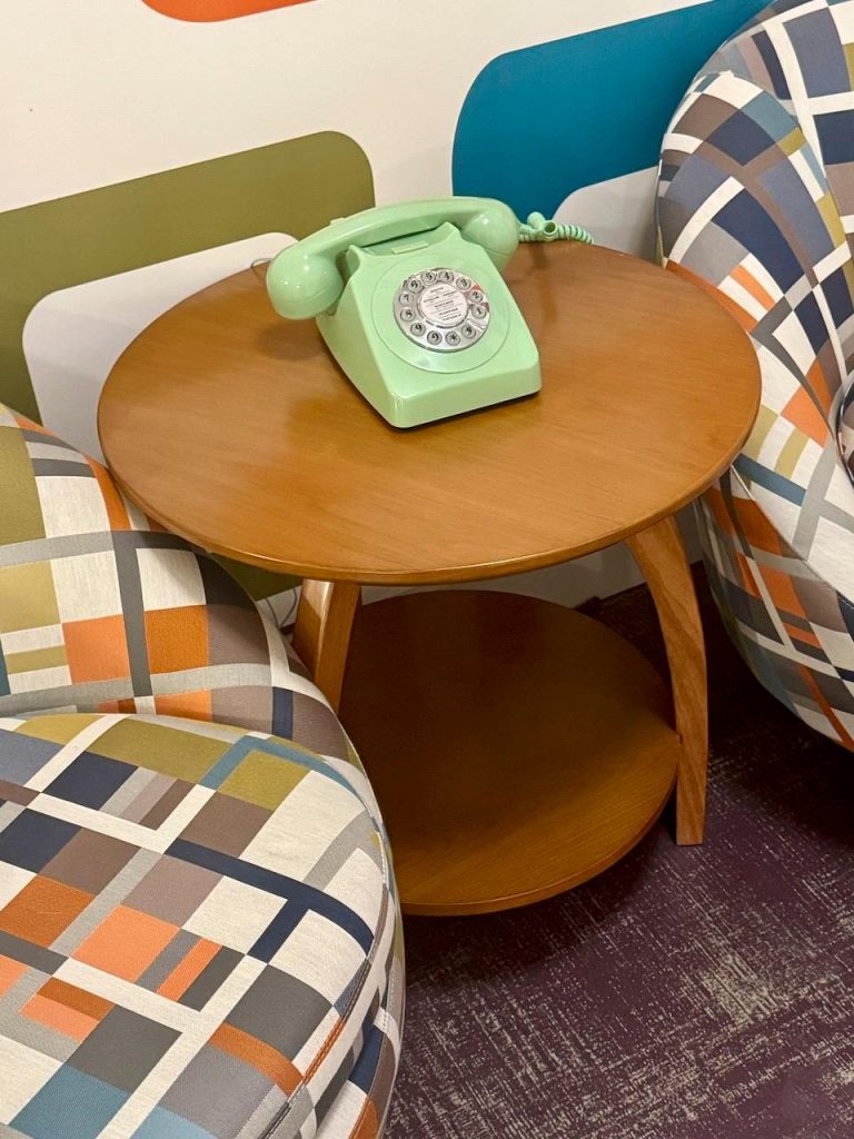 bright green antique telephone on an end table